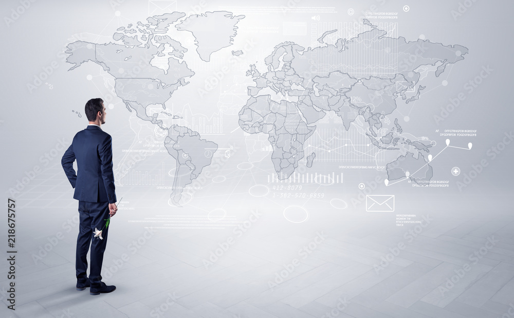 Businessman standing with his back and looking at a worldwide map with objects in his hand
Businessman standing with his back and looking at a worldwide map with objects in his hand