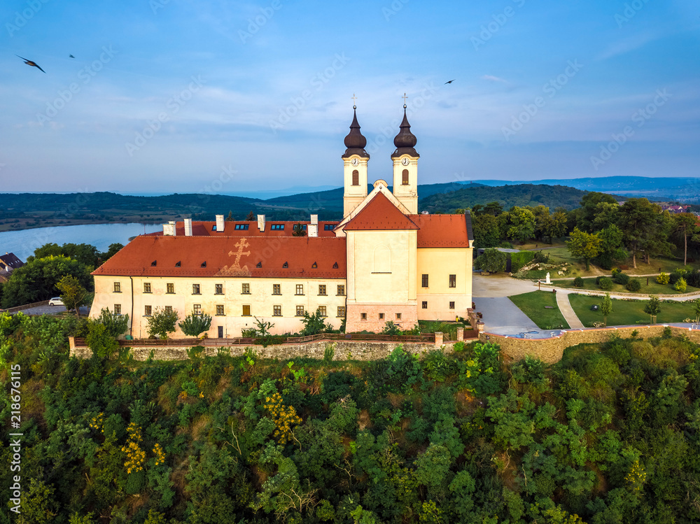 Tihany, Hungary - Aerial view of the famous Benedictine Monastery of Tihany (Tihany Abbey) at sunrise with birds in the air Tihany, Hungary - Aerial view of the famous Benedictine Monastery of Tihany (Tihany Abbey) at sunrise with birds in the air