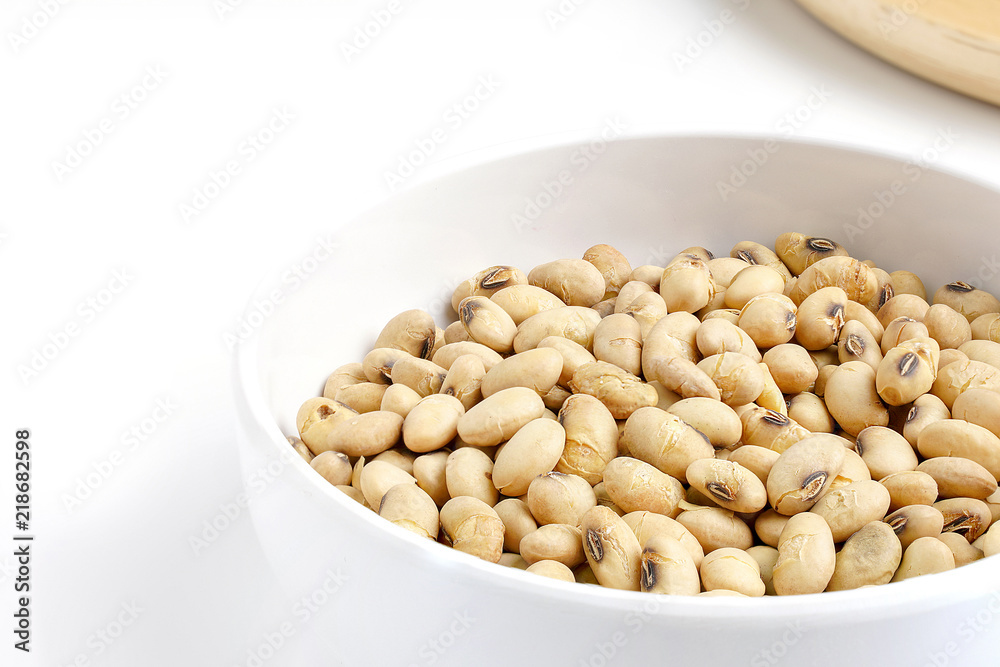 Roasted Soy in White Ceramic Bowl and Round Wood Dish isolated on White Background.