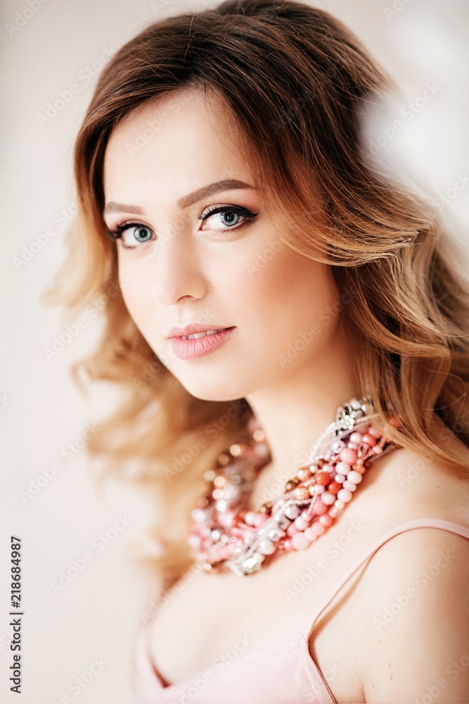 Portrait of beautiful young woman in exquisite jewelry. Fashion photo