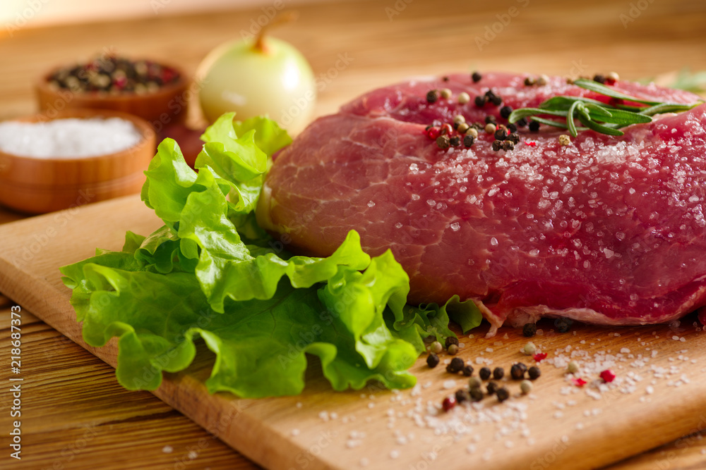 raw fresh meat on the table for cooking with salad and spices raw fresh meat on the table for cooking with salad and spices