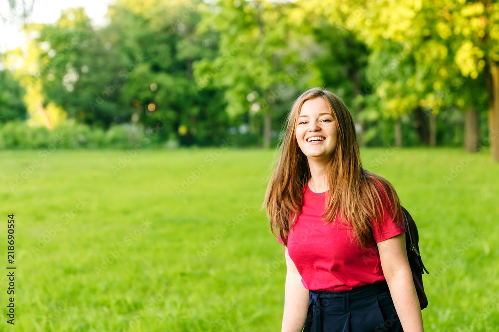 Happy student girl with notes and backpack. Entering the university, starting school in September