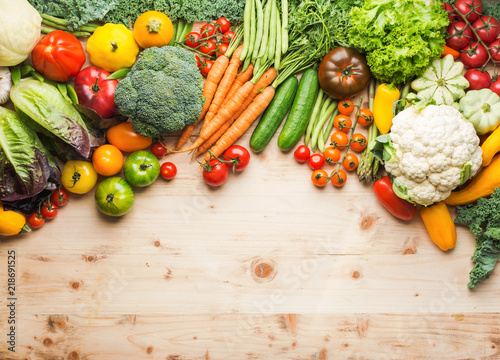 Fresh farm produce, organic vegetables on wooden pine table, healthy background, copy space for text on the bottom, top view, selective focus