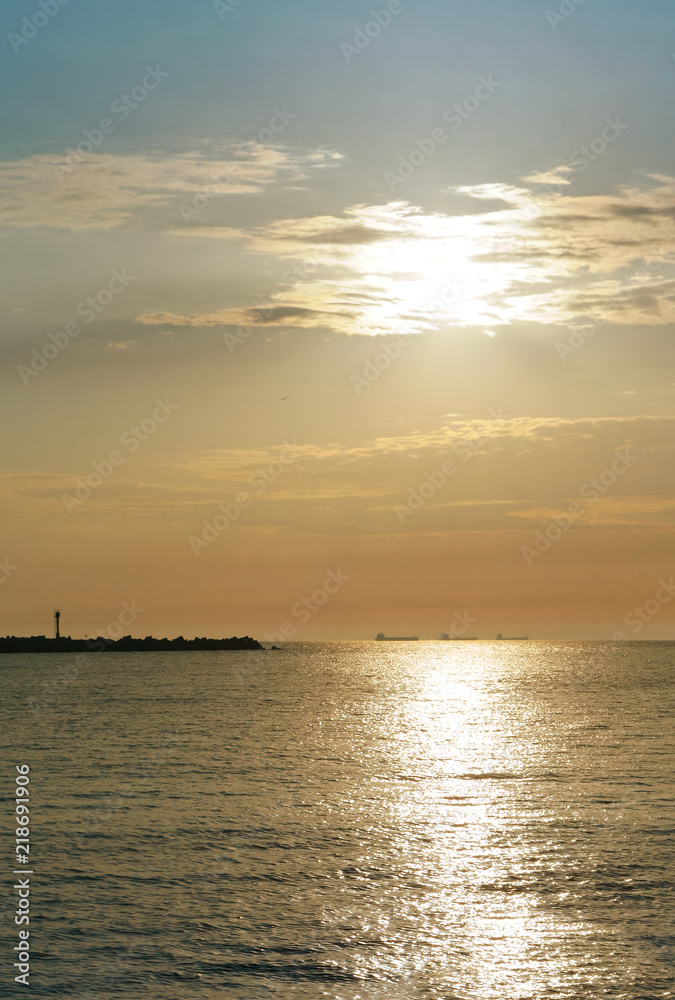 Sunset over the sea. Reflection of sunlight in the sea waves. Red sky in the rays of the sunset. Sunset over the sea. Reflection of sunlight in the sea waves. Red sky in the rays of the sunset.