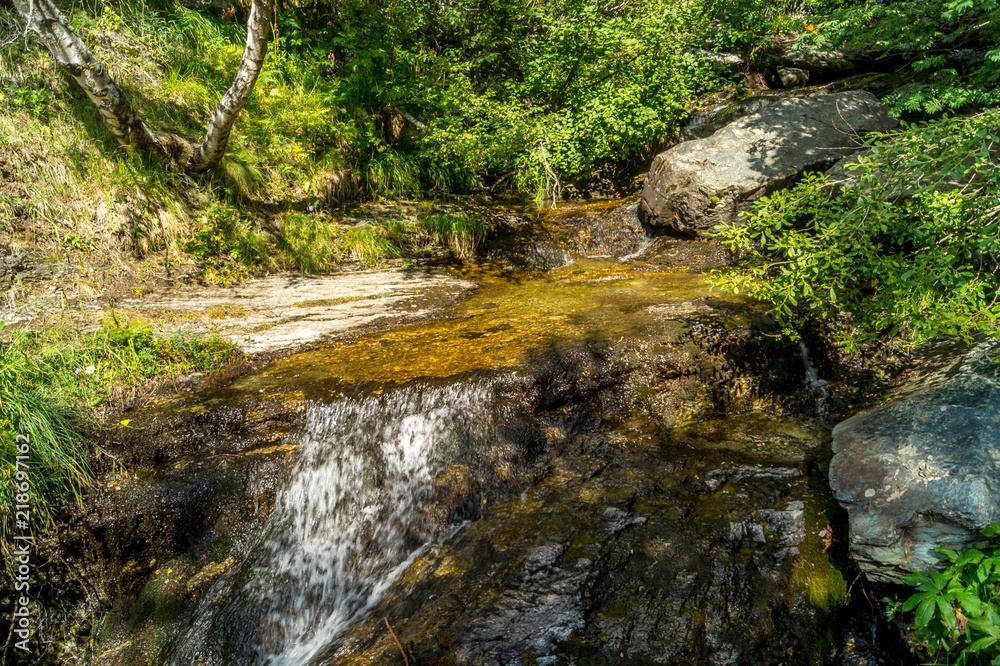 waterfall in the mountains among the rocks