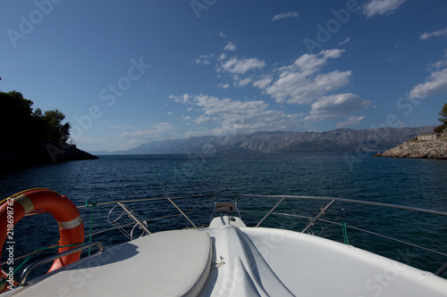 Croatia view of the mountain massif from the boat , view from the speedboat on the Adriatic Sea and the mountain range, photo with space for text, motor boat with lifebuoy view on the bow