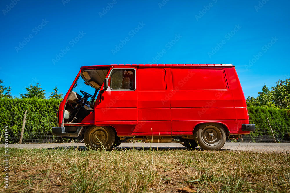 Old retro red minibus on blue sky background
