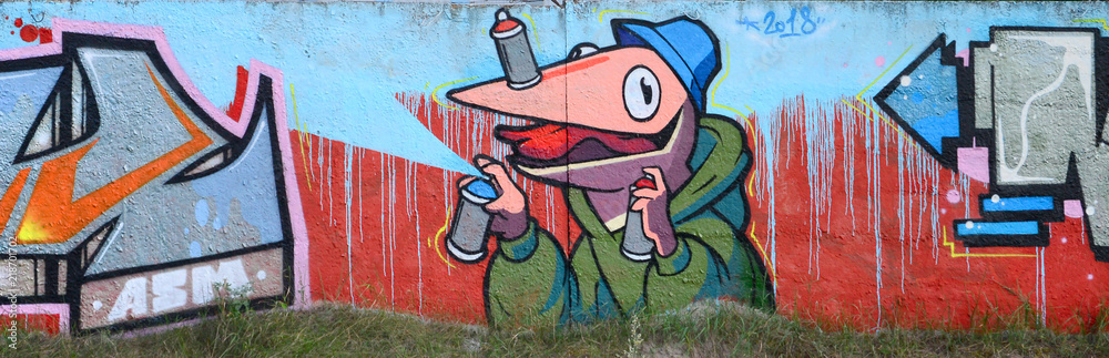 Full and acomplished graffiti artwork. The old wall decorated with paint stains in the style of street art culture. Colored background texture