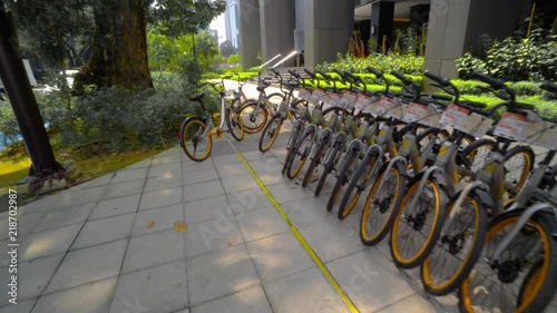 Many bicycles stand in a row in street parking in Kuala Lumpur Malaysia. Ecologically clean transport. View of the wheels. 4K