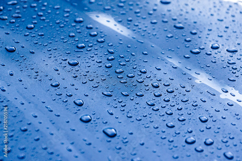 Water drops on a metalic grey car background