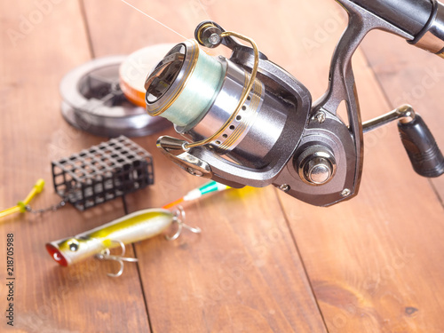 Spinning reel on the background of fishing gear. Close-up