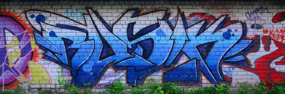 Obraz premium Full and acomplished graffiti artwork. The old wall decorated with paint stains in the style of street art culture. Colored background texture