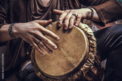 Ethnic percussion musical instrument jembe and male hands