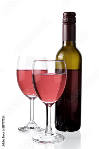 Red wine in glass and bottle isolated on white background.