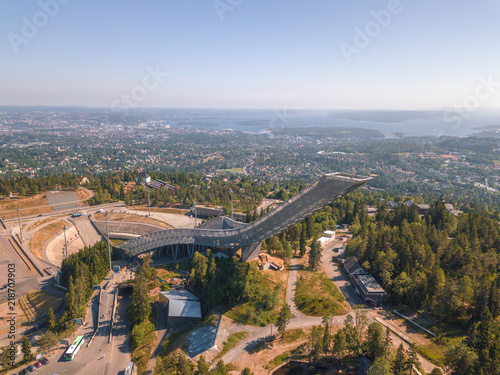 Aerial of Holmenkollen  Ski Museum and Ski Jump Tower in Oslo, Norway. Oslofjord can be seen in far distance photo
