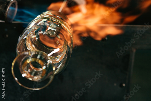 A glassmaker fires a decanter 