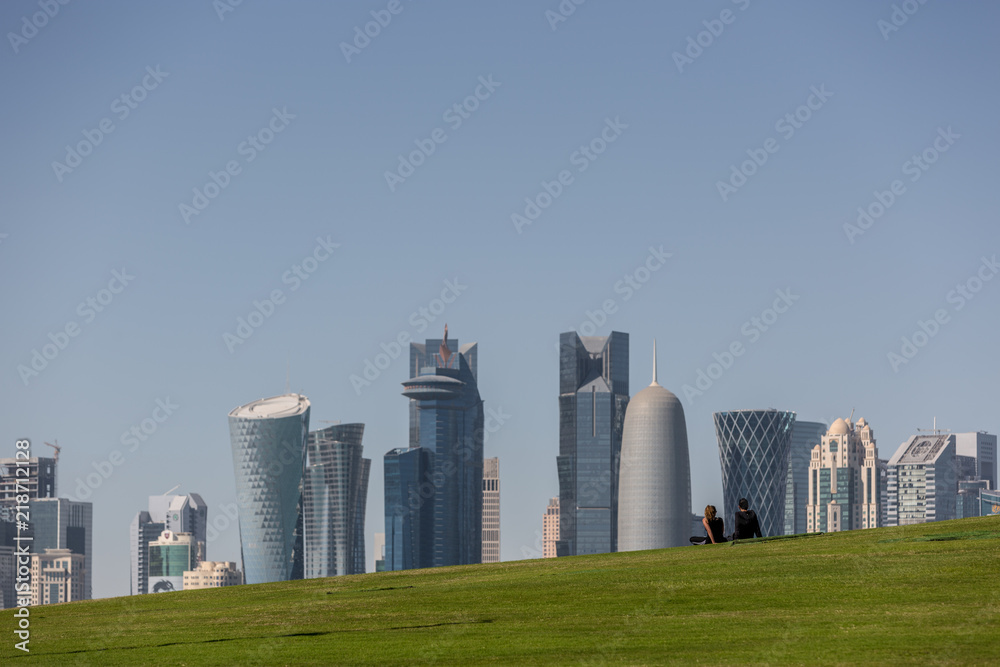 Fototapeta premium Doha, Qatar - Jan 8th 2018 - A young couple enjoy the view of the skyline of Doha's downtown in Qatar