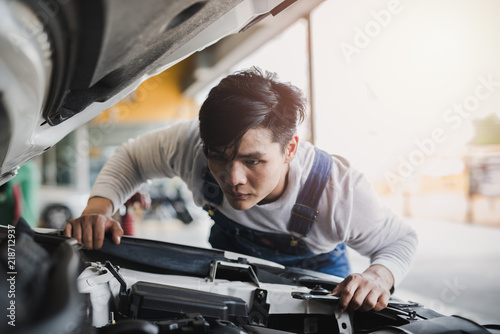 Young Asian machine technicians are analyzing symptoms of broken car at service center repair
