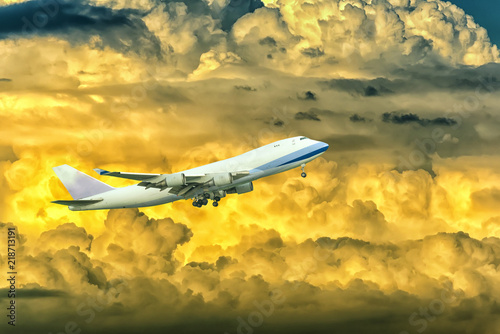 Fototapeta Naklejka Na Ścianę i Meble -  Landscape with airplane is flying through the clouds. Passenger aircraft is landing at dusk. Business trip. Commercial plane.Travel