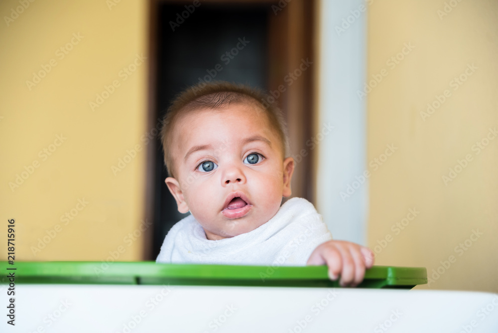 Baby boy playing inside the plastic basin - with cloth diaper on the neck Baby boy playing inside the plastic basin - with cloth diaper on the neck