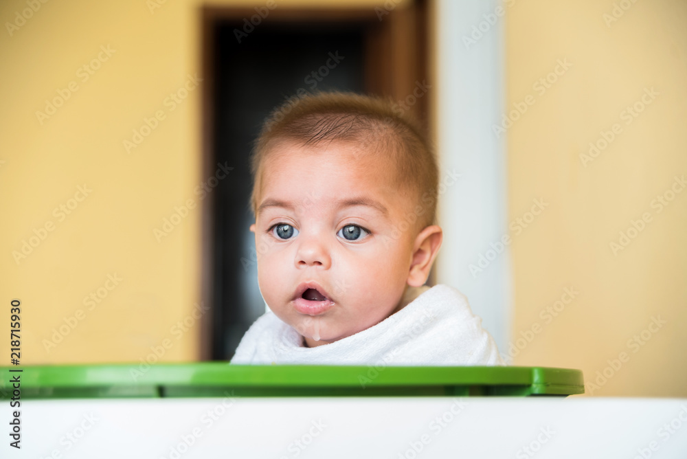 Baby boy playing inside the plastic basin - with cloth diaper on the neck - drooling Baby boy playing inside the plastic basin - with cloth diaper on the neck - drooling