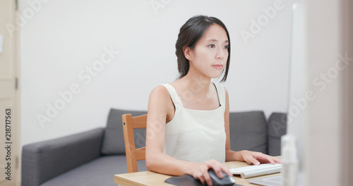Woman working on computer at home