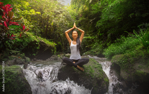 Serenity and yoga practicing at waterfall