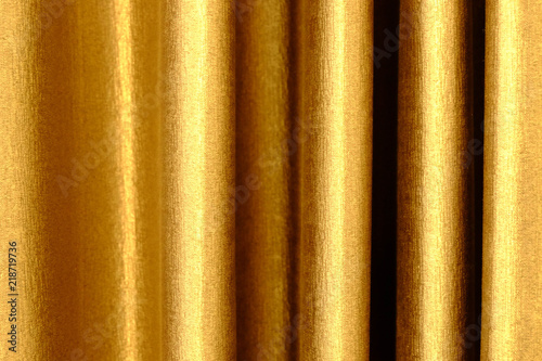 the background dark shiny brown with gold fabric.
