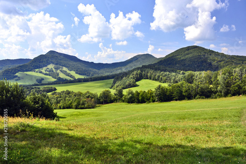 Beautiful summer landscape in the mountains with green meadows and forested hills, Low Beskids (Beskid Niski). 