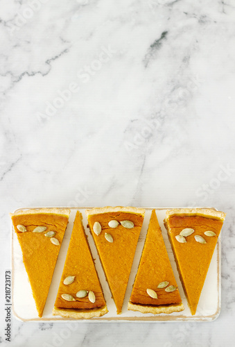 Traditional American pumpkin pie for Thanksgiving Day or Halloween on a light background. Rustic style.