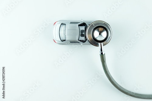 Stethoscope checking up the car on white background, Concept of car check up, repair and maintenance..