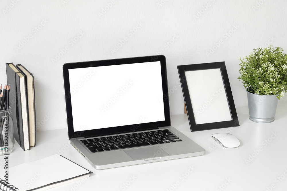 Workspace with Mockup laptop computer on white table with office supplies. Workspace with Mockup laptop computer on white table with office supplies.