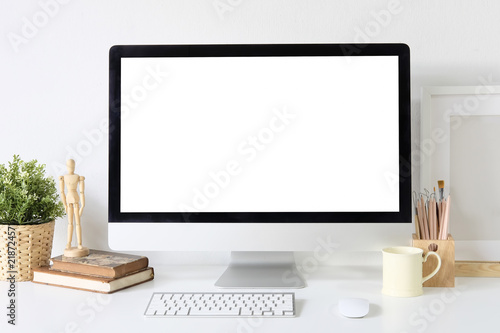 Workspace stylish creative table with mockup computer and designer accessories.