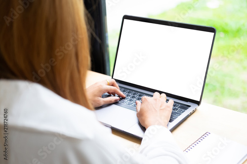 Woman using mockup laptop computer.