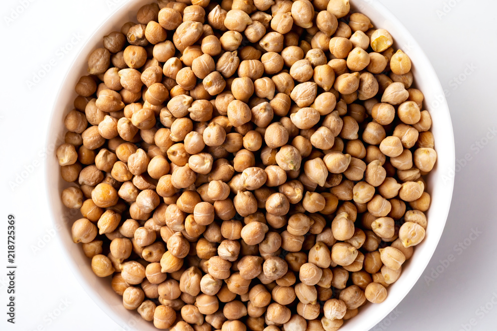 Closeup top view bowl of uncooked chickpeas isolated at white background. Closeup top view bowl of uncooked chickpeas isolated at white background.