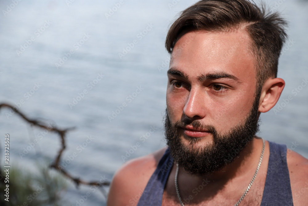 Fototapeta premium Handsome young man near sea on rocks in Turkey