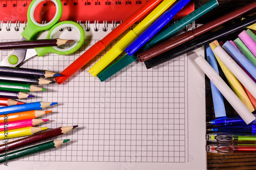 Different school stationeries on a dark wooden table. Top view