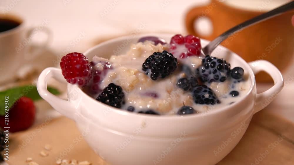 Person taking a spoon of breakfast cereal Person taking a spoon of breakfast cereal