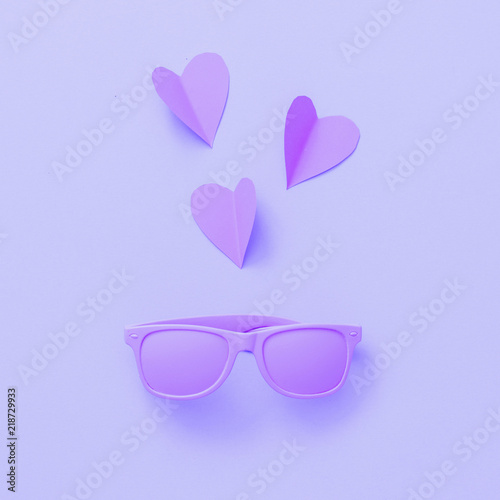 Sunglasses painted in purple with hearts made of paper. Fashion accessories for woman.