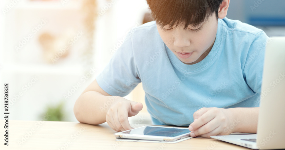 Asian boy watching on tablet computer ,smile face .