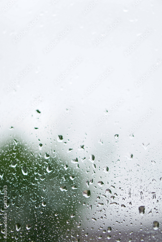 Rainy, autumn weather outside the window. Drops of water on the glass on a blurred background. Romantic grubby topic. Stock photo for design Rainy, autumn weather outside the window. Drops of water on the glass on a blurred background. Romantic grubby topic. Stock photo for design
