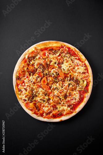 Bolognese pizza. Hot pizza on black background for lunch or dinner crust. Pizza menu