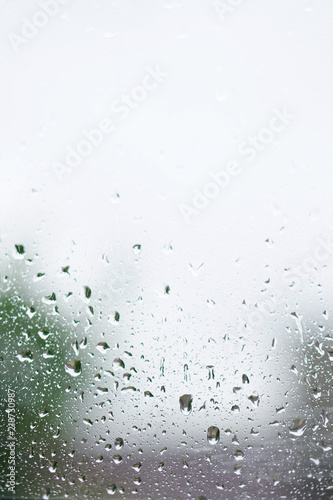 Rainy, autumn weather outside the window. Drops of water on the glass on a blurred background. Romantic grubby topic. Stock photo for design © subjob
