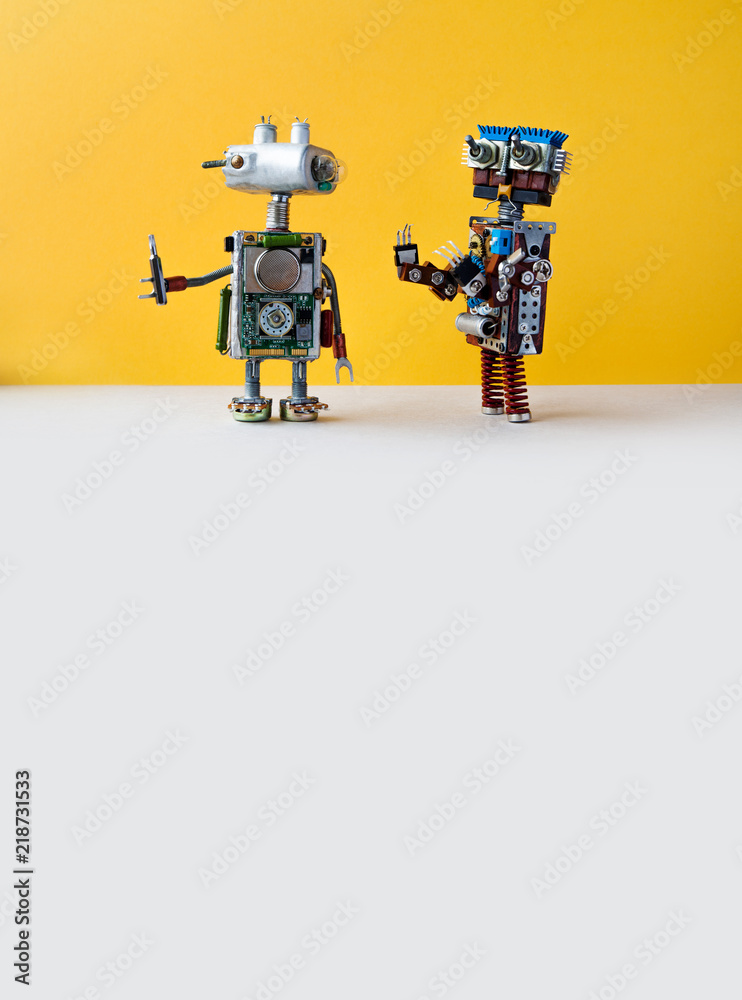 Robots on yellow background. 4th industrial revolution automation concept. Robotic serviceman with screwdriver, creative design cyborg toys. Maintenance repair fix concept. copy space