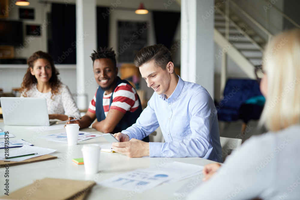 Group of business people sitting at the table and planning work together at meeting Group of business people sitting at the table and planning work together at meeting