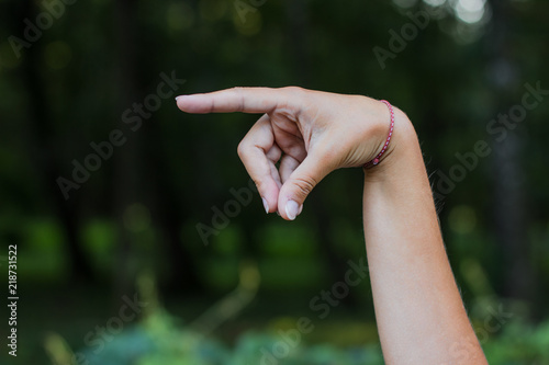 dactyl sign and symbols alphabet concept of human hand and fingers with letters on unfocused blurred dark bokeh natural background environment with empty space for copy or text © Артём Князь