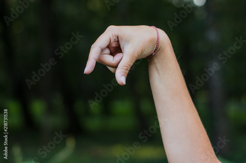 dactyl sign and symbols alphabet concept of human hand and fingers with letters on unfocused blurred dark bokeh natural background environment with empty space for copy or text © Артём Князь