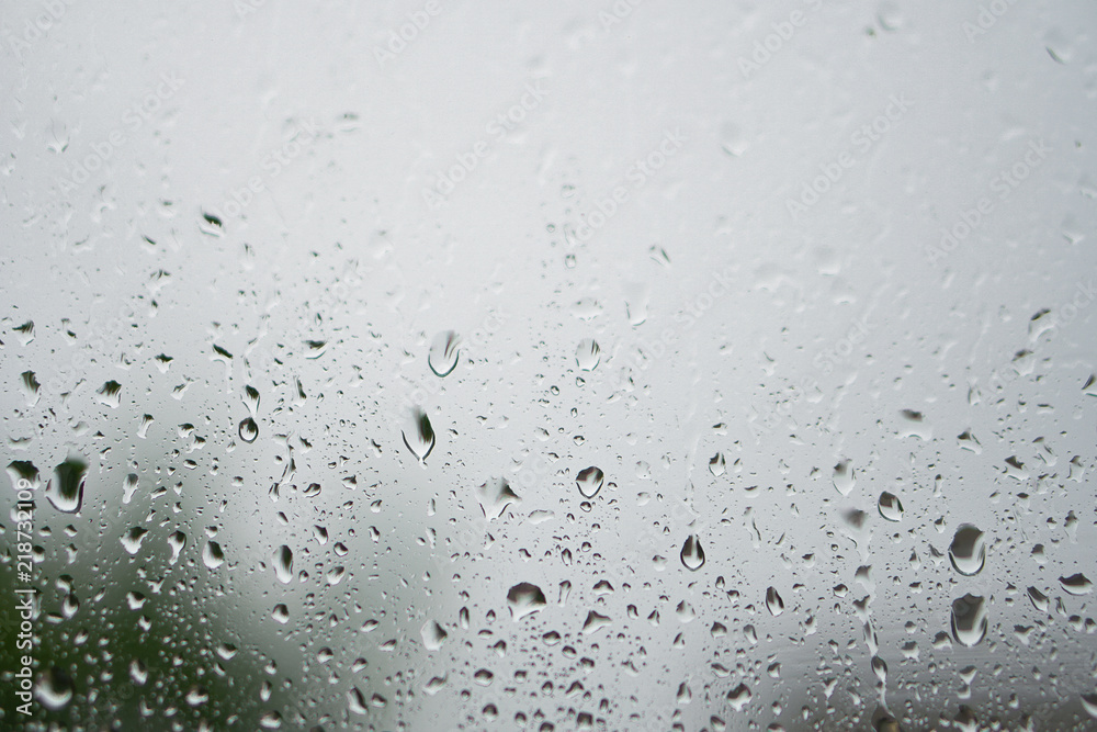 Rainy, autumn weather outside the window. Drops of water on the glass on a blurred background. Romantic grubby topic. Stock photo for design Rainy, autumn weather outside the window. Drops of water on the glass on a blurred background. Romantic grubby topic. Stock photo for design