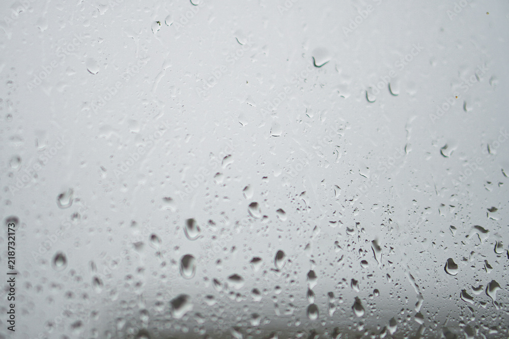 Rainy, autumn weather outside the window. Drops of water on the glass on a blurred background. Romantic grubby topic. Stock photo for design Rainy, autumn weather outside the window. Drops of water on the glass on a blurred background. Romantic grubby topic. Stock photo for design