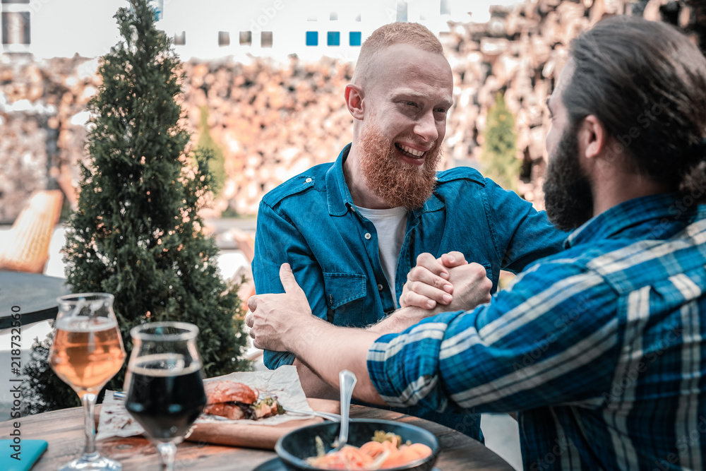Two brothers. Two bearded brothers feeling happy finally seeing each other after very long break